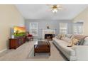 Cozy living room with fireplace, large windows, and plush seating, perfect for relaxation at 174 Whetstone Way, Villa Rica, GA 30180