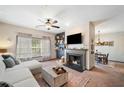 Inviting living room with fireplace, TV, sofa, dining area and lots of natural light at 407 The Crossings Ln, Woodstock, GA 30189
