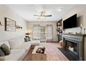 Comfortable living room with fireplace, TV, large sectional sofa, and natural light at 407 The Crossings Ln, Woodstock, GA 30189