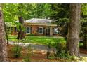 Inviting brick home with a well-maintained lawn and mature trees offering great curb appeal at 4183 Paran Pines Nw Dr, Atlanta, GA 30327