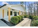 Inviting front porch with natural wood columns and lush landscaping at 6313 Shoreland Cir, Buford, GA 30518