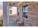 Charming covered front porch features ample natural light, brick detail, and cozy seating at 1436 Maston Rd, Auburn, GA 30011