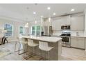 Modern kitchen featuring a large island, stainless steel appliances, and beautiful pendant lighting at 2623 Bloom Cir, Tucker, GA 30084