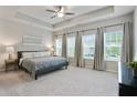 Spacious main bedroom with tray ceilings, neutral colors, and large windows at 2623 Bloom Cir, Tucker, GA 30084