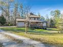 Charming two-story home on a large lot with mature trees and covered deck at 8445 Vernon Grove Rd, Chattahoochee Hills, GA 30268
