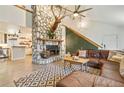 Cozy living room featuring a stone fireplace, a mounted deer head, and comfortable leather furniture at 8445 Vernon Grove Rd, Chattahoochee Hills, GA 30268