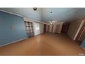 Spacious living room with wood-look floors, neutral walls, and multiple doorways, defurnished using Matterport AI at 111 Oak Grove Rd, Temple, GA 30179