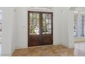 Inviting foyer with beautiful tile flooring and a view of the home's exterior through the front doors at 6230 Hampton Highlands Dr, Cumming, GA 30041