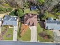 Aerial view of a beautiful home with a large backyard, mature trees, and a spacious driveway at 708 Larkspur Nw Blvd, Acworth, GA 30102