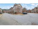 Exterior view of residential street with townhomes and parked cars at 1952 Appaloosa Mill Cir, Buford, GA 30519