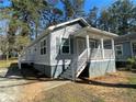 Charming home with a covered front porch and well-maintained lawn at 2938 Palm Dr, Atlanta, GA 30344