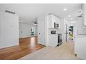 Bright kitchen with white cabinetry and stainless appliances flowing into a living area at 5225 Maple Valley Sw Rd, Mableton, GA 30126