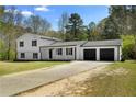 Charming two-story home featuring a long driveway leading to a two car garage at 3351 Grand Central Dr, Snellville, GA 30078