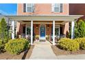 Inviting covered porch with rocking chairs, creating a warm and welcoming entry at 4121 N Swann St, Covington, GA 30014