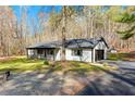 Charming single-story home with an attached garage, driveway, and a well-maintained lawn surrounded by trees at 5785 Woodruff Rd, Chattahoochee Hills, GA 30213