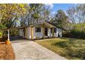 Exterior of well-kept home with a covered carport and landscaped lawn at 1275 Calhoun Ave, Atlanta, GA 30344
