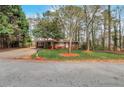 Traditional brick ranch home surrounded by mature trees and landscaping at 1334 Jennie Sw Ln, Lilburn, GA 30047