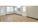 Bright living area with tiled flooring, a back door and a side entrance at 1334 Jennie Sw Ln, Lilburn, GA 30047