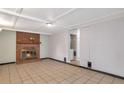 Cozy living room showcasing a brick fireplace and neutral tile flooring at 1334 Jennie Sw Ln, Lilburn, GA 30047