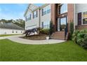 Close-up of a home's brick-accented entrance with a curved walkway and manicured landscaping at 15 Glen Echo Dr, Covington, GA 30016