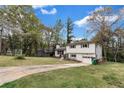 Split-level home featuring an attached garage, yellow door and a long driveway at 3632 Glen Mora Drive, Decatur, GA 30032