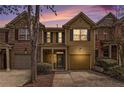 Attractive townhouse with a warm exterior, showcasing a cozy front porch and attached garage at 2728 Keystone Gates Ct, Lithonia, GA 30058