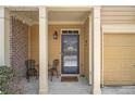 Inviting front porch with decorative chairs and plants, leading to a charming front door at 2728 Keystone Gates Ct, Lithonia, GA 30058