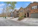 A row of townhouses featuring diverse exteriors and well-maintained front lawns, creating curb appeal at 2728 Keystone Gates Ct, Lithonia, GA 30058