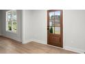 The interior features a wood door, hardwood floors, and a window providing natural light at 5010 Hyde Way, Cumming, GA 30040