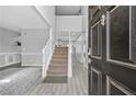 Welcoming foyer with staircase and elegant light fixtures at 1151 Adah Ln, Lawrenceville, GA 30043