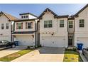 Attractive townhomes featuring painted white brick, black trim and a convenient one-car garage at 228 Auburn Valley Way, Auburn, GA 30011