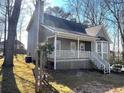 Lovely home featuring a covered porch, bay window, and well-kept landscaping at 1924 Sidneys Cv, Lawrenceville, GA 30043