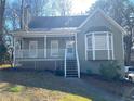 Attractive home with a welcoming front porch, bay window, and manicured landscaping at 1924 Sidneys Cv, Lawrenceville, GA 30043