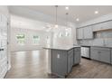Open concept kitchen with gray cabinets, granite countertops, stainless appliances, and spacious dining area at 317 Skye Ln # 51, Cartersville, GA 30121