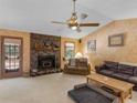 Comfortable living room with stone fireplace, neutral walls, and abundant natural light at 5 Ridgewood Cir, Mcdonough, GA 30252