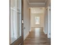 Inviting hallway featuring beautiful hardwood floors and natural light, creating a warm welcome at 502 Clayborne Way, Loganville, GA 30052