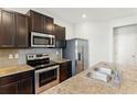 Modern kitchen with granite countertops, stainless steel appliances, dark cabinetry and tile backsplash at 5634 Union Pointe Dr, Union City, GA 30291