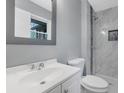 Updated bathroom featuring a vanity, toilet, shower with marble wall tiles at 1513 Spruce Ridge Way, Stone Mountain, GA 30083
