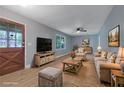 Inviting living room with wood floors, ceiling fan, soft blue walls and comfortable seating at 1513 Spruce Ridge Way, Stone Mountain, GA 30083