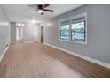 Open-concept living room with lots of natural light, ceiling fan and wood-look vinyl floors at 1513 Spruce Ridge Way, Stone Mountain, GA 30083