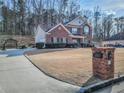 Exterior view of a two-story brick home with an extended driveway and manicured front lawn at 1763 Emerald Dr, Jonesboro, GA 30236