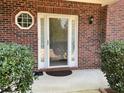 Close-up view of the front door entrance, with a brick facade and well-maintained landscaping at 1763 Emerald Dr, Jonesboro, GA 30236
