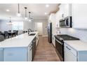 Modern kitchen with stainless steel appliances, white cabinetry, and a spacious countertop at 3739 Silvery Way, Powder Springs, GA 30127