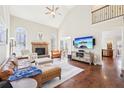 Open living room with a fireplace, large windows, and hardwood floors throughout the house at 110 Canyon Ridge Trl, Canton, GA 30114