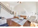 Bright and airy living room featuring a staircase, hardwood floors, and a cozy seating area at 110 Canyon Ridge Trl, Canton, GA 30114
