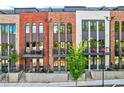 Stylish townhomes with arched windows, small balconies, and well-maintained front yards at 1239 Chelsea Nw Cir, Atlanta, GA 30318