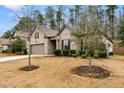 Side view of a one-story home with a two-car garage and landscaped yard in a neighborhood setting at 736 Red Wolf Run, Atlanta, GA 30349