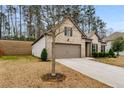 Side view of a one-story brick home featuring a two-car garage and landscaped yard at 736 Red Wolf Run, Atlanta, GA 30349