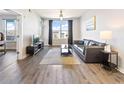 Bright living room featuring hardwood floors and a large window with city views at 390 17Th Nw St # 5031, Atlanta, GA 30363