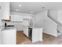 Stylish kitchen featuring stainless steel appliances, granite countertops and hardwood floors at 213 Groveton Ct, Euharlee, GA 30145